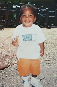 adoption in the 1980s | black baby boy in tee shirt and shorts