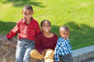 National Foster Care Month | three African American brothers who are waiting to be adopted smiling