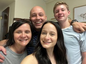 A group shot of a family smiling. 